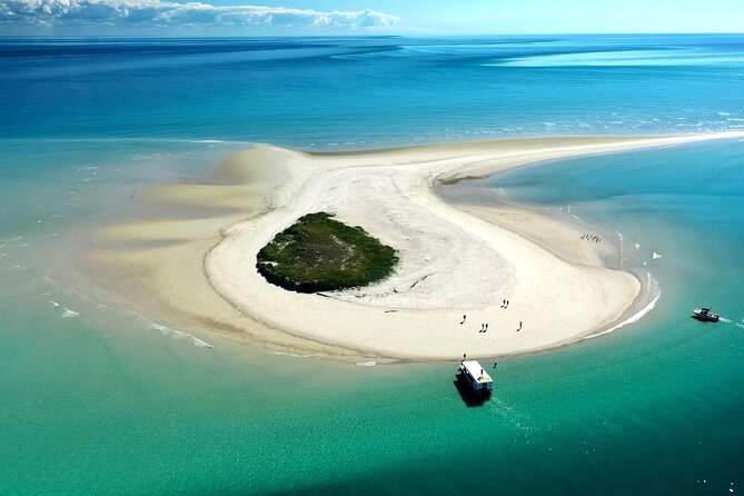 Boat on beach of small island in the Great Sandy Marine Park