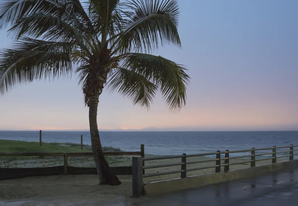 Moreton Island's coastline with Tangalooma Wrecks visible underwater.
