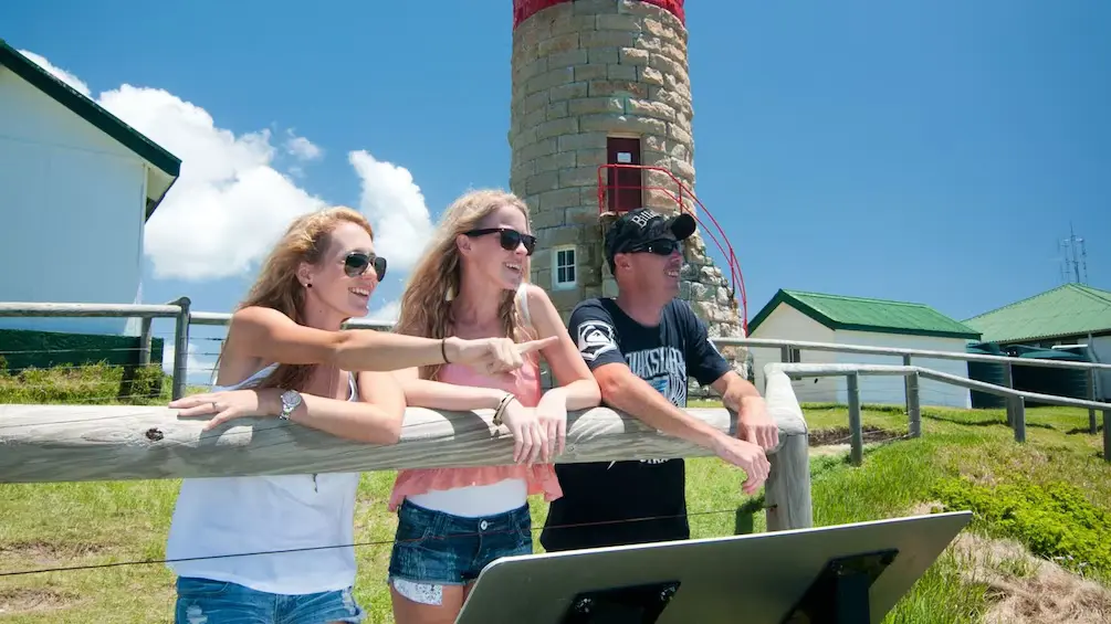 people standing in front of Moreton Island lighthouse