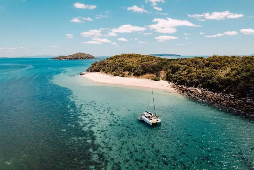 Catamaran in front of island of capricorn coast